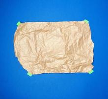 crumpled brown sheet of parchment paper glued with green paper Velcro photo