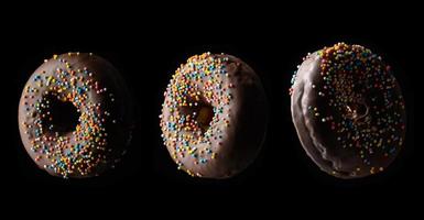 chocolate donuts with multicolored sprinkles levitate on a black background photo