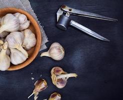 Fruits of garlic in a wooden bowl photo
