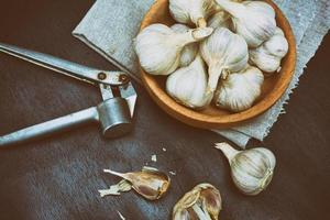 Harvest garlic in husk in a wooden bowl photo