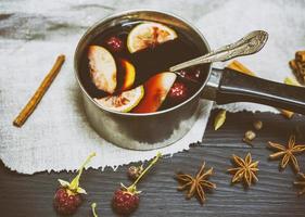 mulled wine in an aluminum ladle photo