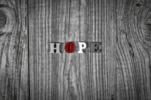 Grey wooden background with the word hope photo