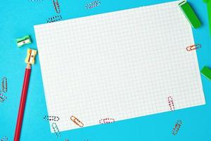 clean white squared paper and red wooden pencil with a sharpener photo