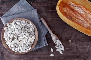 Pumpkin seeds in a wooden bowl photo