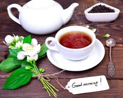 hot black tea in a white cup with a saucer photo