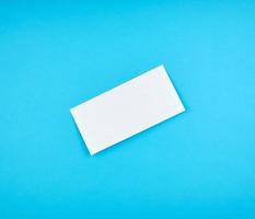 white rectangular paper envelope on a blue background photo