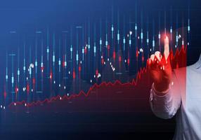 Graph of price growth and indicators. Analysis of indicators on a virtual screen by a businessman in a suit. Growth of business indicators, high profit photo