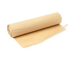 roll of brown parchment paper isolated on white background, for baking photo