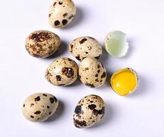 Raw quail eggs on white background photo