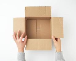open empty square brown cardboard box for transportation and packaging of goods photo