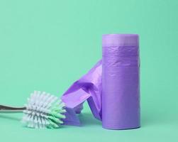 skein of purple plastic trash bags with strings on a green background photo