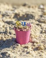 cubo de hierro para bebés lleno de letras coloridas de madera, sol de inscripción foto