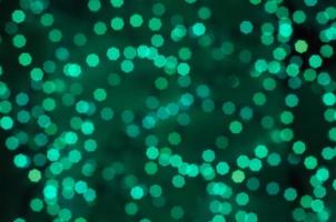 Green bokeh polygon on a dark background photo