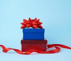 stack of wrapped gifts with knotted bows on a blue background photo