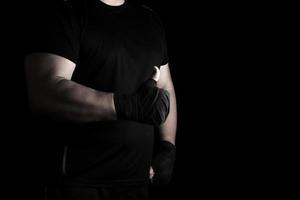 hands wrapped in black elastic sports bandage show a like sign photo