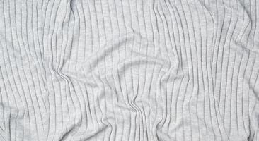 fragment of gray knitted fabric, full frame, fabric for sweaters photo