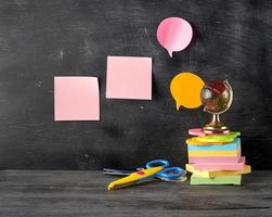 stack of multi-colored sticky stickers, glass globe, scissors photo