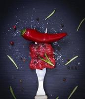 two pieces of beef and red chili pepper photo