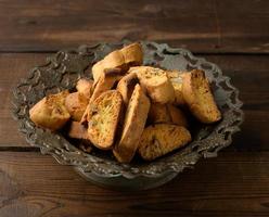 pieces of baked italian christmas biscotti cookies in a metal plate photo