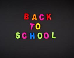 inscription back to school from multi-colored plastic letters photo