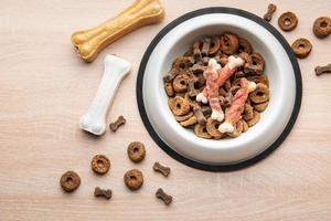 un plato de comida para perros en un piso de madera. foto