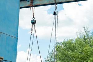 old iron structure with hook chains on the street photo