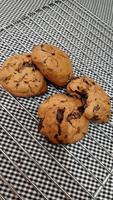 Chocolate chip cookies on a baking sheet ready for eat photo