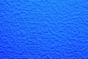 blue foam texture with uneven wavy surface, full frame photo