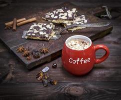 red ceramic mug with coffee and marshmallows photo