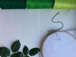 Wooden hoop, fabric and thread for embroidery and sewing photo