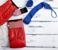 pair of leather red boxing gloves and blue bandage photo