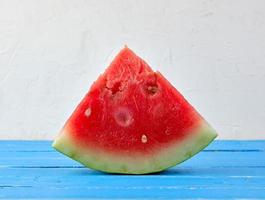 sliced triangles ripe red round watermelon with seeds photo