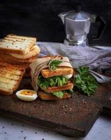 sandwich of French toast and lettuce leaves and boiled egg photo