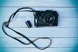 Retro film camera on a blue wooden surface photo