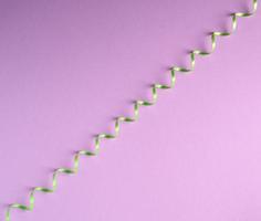 green paper serpentine on a lilac background photo