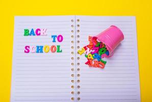 colorful wooden letters on a notebook photo