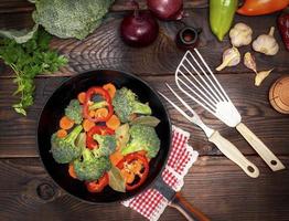 fresh vegetables in a black round frying pan photo