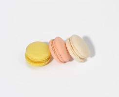 round multicolored macarons on a white background with a shadow photo