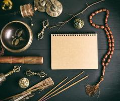 Asian religious musical instruments for meditation and notebook photo