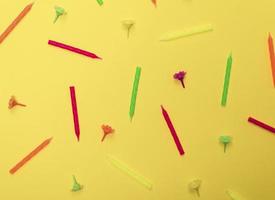 yellow background with wax candles for celebratory cake photo