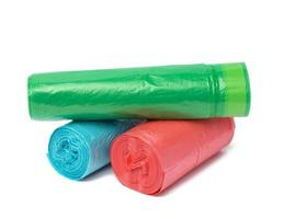 stack of polyethylene multicolored disposable trash bags on white background photo