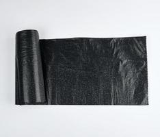 black plastic bag for garbage on a white background photo