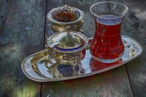 Black tea in a traditional Turkish cup on a silver platter photo