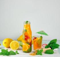 summer refreshing drink lemonade with lemons, mint leaves photo