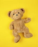 brown teddy bear on a yellow background photo