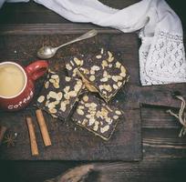 red ceramic mug with coffee on a brown wooden background, top view photo