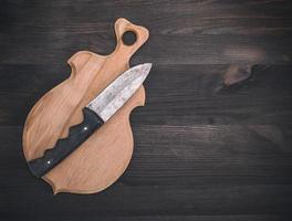 wooden cutting board and old knife photo