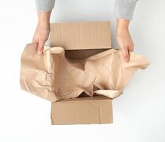 open empty square brown cardboard box for transportation and packaging of goods photo