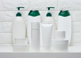 White plastic jars and tubes for liquid cosmetics on a white background photo