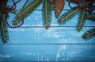 Vintage background with branches of spruce with a garland of red photo